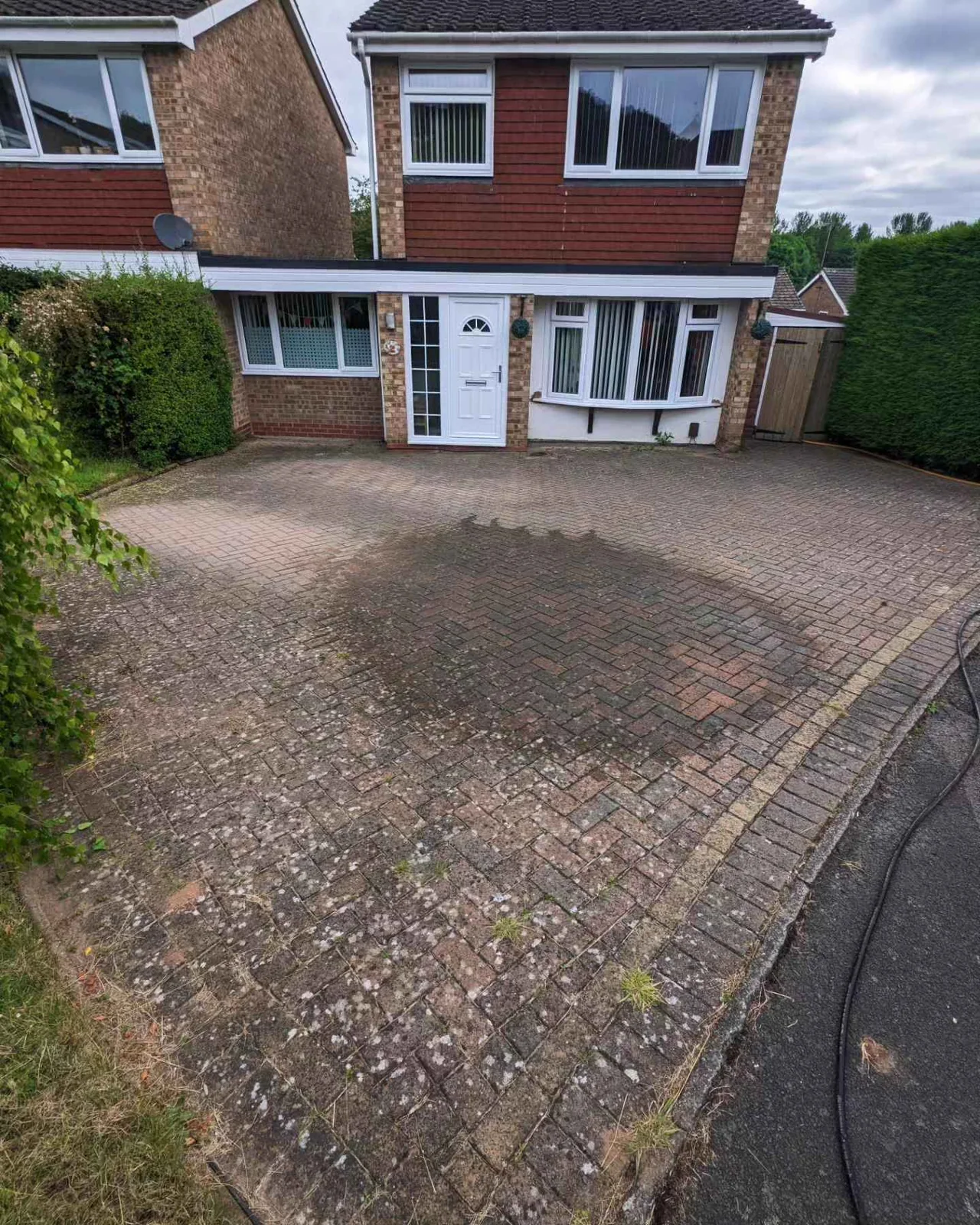 Dirty block paved driveway before pressure washing